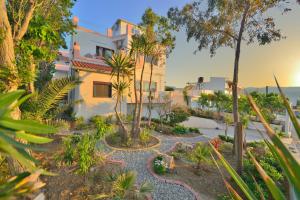 a garden in front of a house with trees at Callista sea view or garden in Kissamos