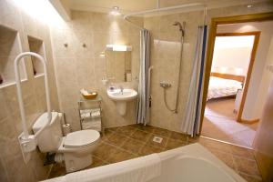a bathroom with a toilet and a shower and a sink at Sebay Mill Holiday Apartments in Toab +56 photos