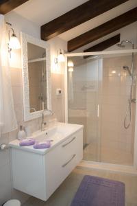 a bathroom with a white sink and a shower at Holiday Home Dora in Rovinj
