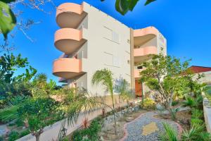 an exterior view of a building with trees and plants at Callista sea view or garden in Kissamos