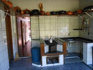 a kitchen with a stove and a sink in it at Casa em Santo Antônio de Lisboa in Florianópolis +20 photos