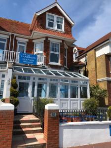 a house with a greenhouse in front of it at The Langtons Bed & Breakfast in Eastbourne