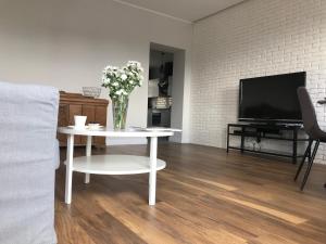 Televízia a/alebo spoločenská miestnosť v ubytovaní Apartament 27