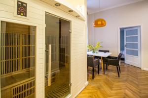 a room with a table and a room with a cage at Vojtesska Apartment By Ruterra in Prague
