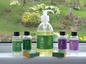 a group of three bottles of soap and a bottle of cleaner at Urquhart Bay B&B in Drumnadrochit