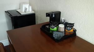 a coffee maker sitting on top of a table at American Regency Inn in Williams