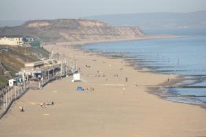 a group of people on a beach next to the ocean at Beach Lodge in Bournemouth