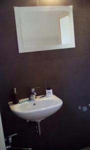 a white sink in a bathroom with a mirror at farmglamping Planika - Encijan in Hraše