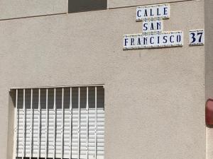 a street sign on the side of a building at Casa el Sol in Lumpiaque +5 photos