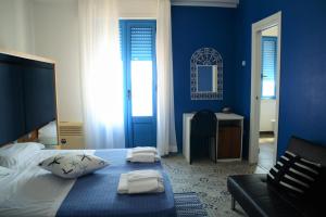 a bedroom with a bed and a window at Hotel La Favorita in Cala Gonone