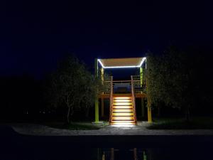 a lit up lifeguard tower at night with stairs at Il Sogno di Alghero - Adults Only in Alghero