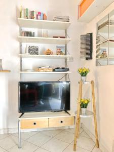 a living room with a tv on a stand at Apartment With Garden in Lucca