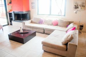 a living room with a couch and a fireplace at Stan&Family in Kalavárda