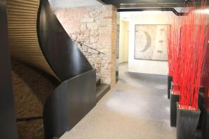 a staircase in a room with a brick wall at Hotel U Tří volů in Lysice