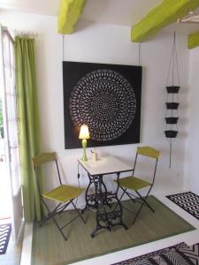 ein Esszimmer mit einem Tisch und 2 Stühlen in der Unterkunft La Joliette in Junas