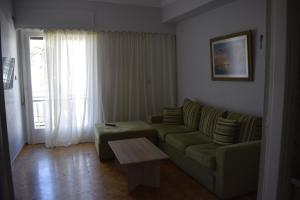 a living room with a couch and a coffee table at Historic Center Apartment at Thisseio in Athens