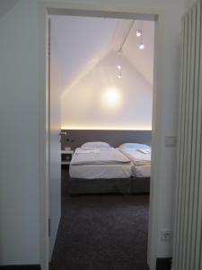 Postel nebo postele na pokoji v ubytování Comfor Hotel Ulm City