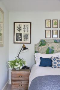 a bedroom with a bed and a lamp on a dresser at The Pheasant Inn in Hungerford