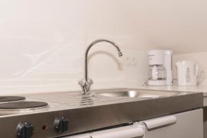 a kitchen with a sink and a counter top at Pension zum Schloss in Hamminkeln +11 photos