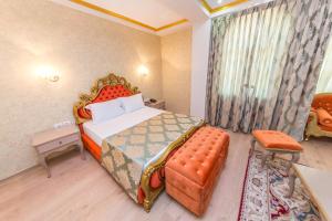 a bedroom with a king sized bed and a chair at Hotel Belagrita in Berat +39 photos