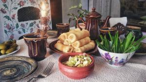 a table with plates and bowls of food on it at Koryakivskyi Rai in Dmitrenki