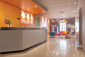 an office lobby with a reception desk and chairs at Hostal Benidorm in Barcelona