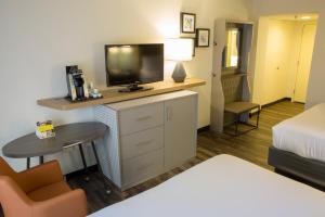 a hotel room with a bed and a tv on a dresser at Holiday Inn Orlando International Airport, an IHG Hotel in Orlando