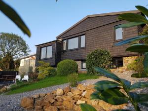 a house with a stone wall in front of it at 1Step2AllCities House&Garden in Wuppertal