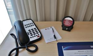 a desk with a cell phone and a keyboard at Best Western Plus Kelowna Hotel & Suites in Kelowna