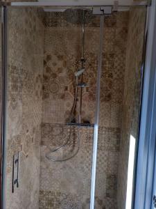 a shower with a hose in a bathroom at Vilamaroto in Meranges