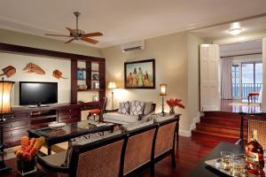 a living room filled with furniture and a tv at Half Moon in Montego Bay