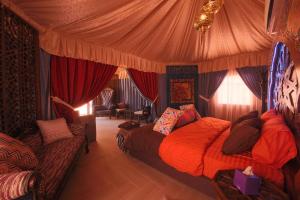 a bedroom with a bed in a tent at Memories Aicha Luxury Camp in Wadi Rum