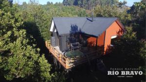 an aerial view of a tiny house in the woods at Parque Natural Rio Bravo Lodge in Castro