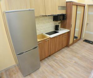 a kitchen with a stainless steel refrigerator at 204 Студия и Комната в Екатерин Квартале in Adler