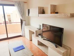 a living room with a large flat screen tv at Bahia sol in Caleta De Fuste