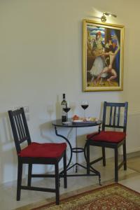 a table and two chairs and a table with a painting at Fountoukli in Kastoria