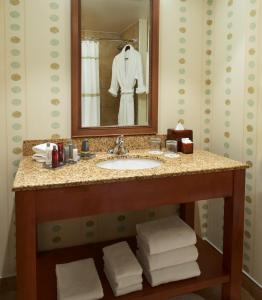 a bathroom with a sink and a mirror and towels at River Cree Resort & Casino in Edmonton