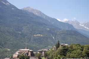a group of houses in front of a mountain at Hotel Le Verger in Châtillon