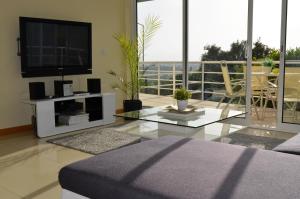 a living room with a flat screen tv and a couch at Luxury Holiday Home Albufeira in Albufeira