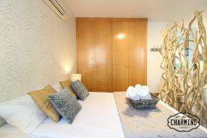 a bedroom with a white bed with a wooden cabinet at Huertas Apartment - Estancias temporales in Madrid