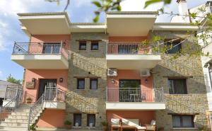 an apartment building with stairs and balconies at Fountoukli in Kastoria