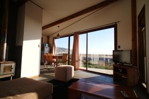 a living room with a large window with a view at Arenaguas Beach House in Matanzas
