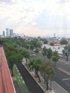 a view of a city street with a bus at Departamento Tu espacio Eje Central 100 y calle Moctezuma, Garibaldi-Lagunilla Subway-Station in Mexico City