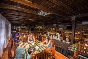 a group of people sitting at a table in a restaurant at Hosteria del Prado in Salta