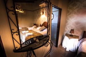 a bedroom with two beds and a mirror at Hosteria del Prado in Salta +15 photos