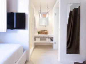 a white bathroom with a white sink and white cabinets at HM Balanguera in Palma de Mallorca