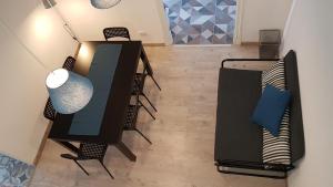 a room with a desk and chairs and a table at Hostel A Casa da Árvore in Faro