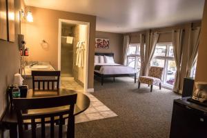 a bedroom with a bed and a table and chairs at Century Casino & Hotel Cripple Creek in Cripple Creek
