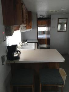 a kitchen with a counter and a sink in an rv at The Canyon Motel & RV Park in Williams