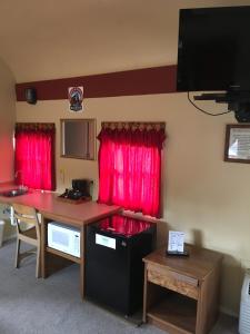 a living room filled with furniture and a tv at The Canyon Motel & RV Park in Williams